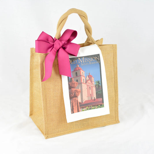 Natural jute tote bag with twisted handles, featuring Old Mission Santa Barbara print and a large pink bow
