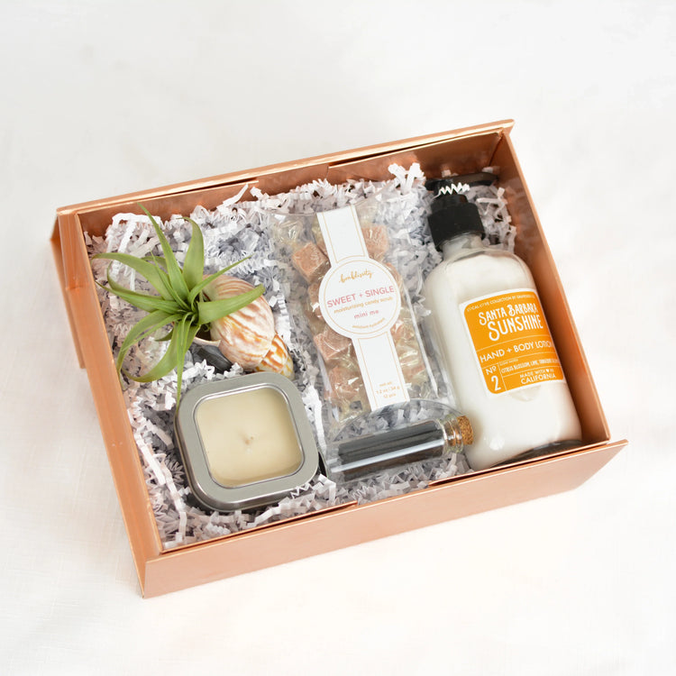 Santa Barbara Sunshine spa gift box with hand lotion, candle, exfoliating candy scrub, air plant, and seashell