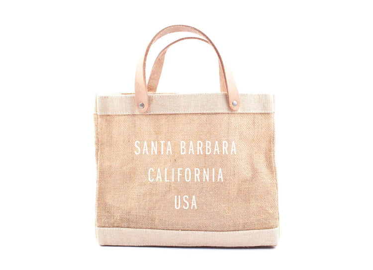 Natural jute tote bag with tan leather handles and white text saying Santa Barbara California USA